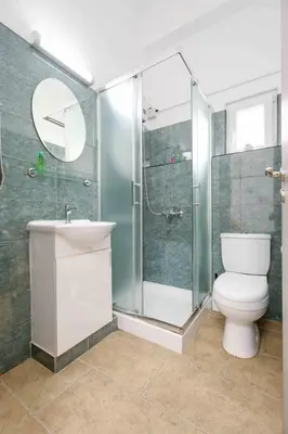 a bathroom with a shower and a toilet and a sink at Сozy and traditional - EC Studios in Larnaka