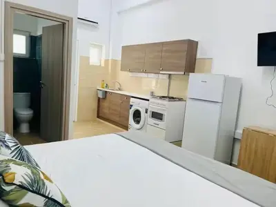 a kitchen with a white refrigerator and a stove at Сozy and traditional - EC Studios in Larnaka