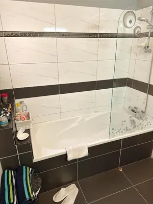 a bathroom with a bath tub and a sink at Modern Penthouse Overlooking Pool in Pyla