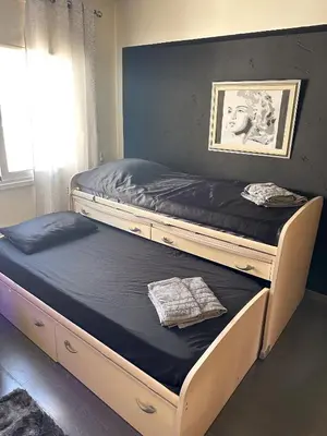 two bunk beds in a room with a window at Modern Penthouse Overlooking Pool in Pyla