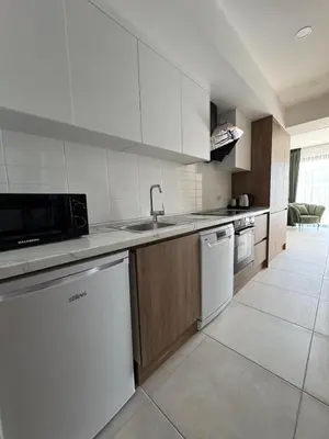 a white kitchen with a sink and a dishwasher at Modern Seaside Studio at Northern Cyprus - Pearl Island in Pyla