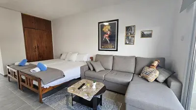 a living room with a couch and a bed at STAY ZEA Studio in Ayia Napa