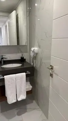 a bathroom with a sink and a mirror at Grand Sapphire 22 floor B BLock 377, Cypr Północny in Paralimni