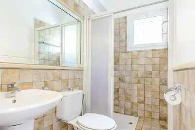 a bathroom with a toilet and a sink and a mirror at Villa Marilena in Protaras