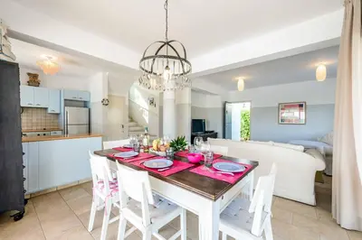 a dining room and kitchen with a table and chairs at Villa Marilena in Protaras