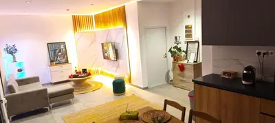 a kitchen and living room with a couch and a table at Light garden in Limassol
