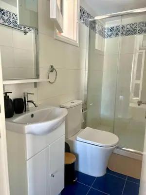 a bathroom with a toilet and a sink and a shower at The Mansion By Penelope in Omodos