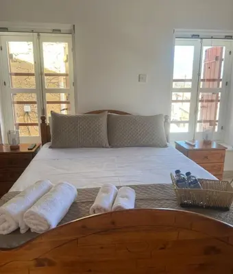 a bedroom with a large bed with towels on it at The Mansion By Penelope in Omodos