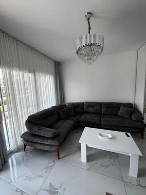 a living room with a couch and a table at Apartman Severny Cyprus in Iskele