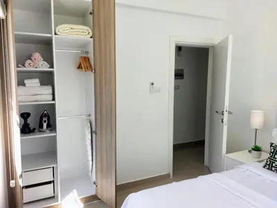 a bedroom with a mirror next to a bed at Amazing Sea View -3 Bed Ground Floor Garden Apartment in Kérynia