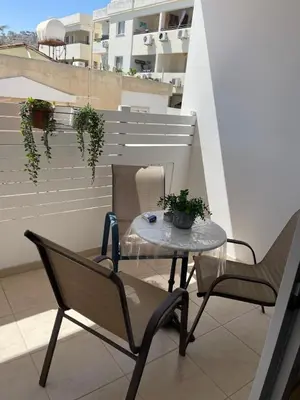 a balcony with a table and chairs on a roof at Sunflower Oroklini in Voroklini