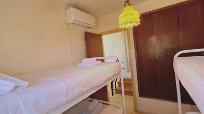 a hospital room with two beds and a yellow light at STAY Sea Gem Apartment in Meneou