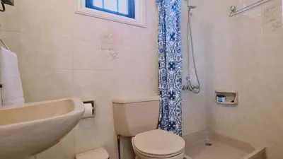 a bathroom with a toilet and a sink and a shower at STAY Sea Gem Apartment in Meneou