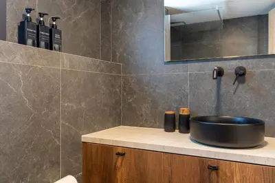 a bathroom with a sink and a mirror at Exquisite 2BR modern village house w private pool in Ayios Tykhonas