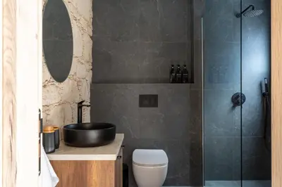 a bathroom with a shower and a toilet and a sink at Exquisite 2BR modern village house w private pool in Ayios Tykhonas