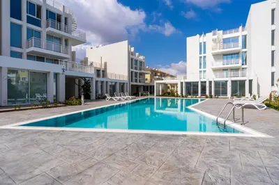 a swimming pool in the middle of a building at Blu Horizon - Stylish Living with Pool & Balconies in Protaras in Paralimni