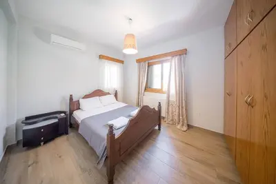 a bedroom with a bed with a dresser and a window at Blue Pearl Villa - 6 Bedroom in Pyla