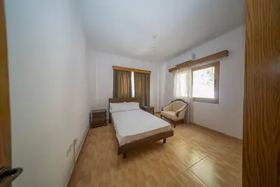 a bedroom with a bed and a chair in it at Blue Pearl Villa - 6 Bedroom in Pyla