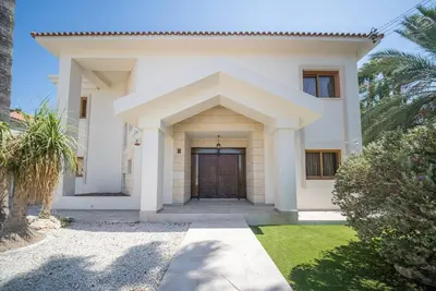 a white house with a large door at Blue Pearl Villa - 6 Bedroom in Pyla