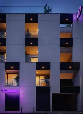 a building with purple lights on the side of it at Aweso Limassol in Limassol