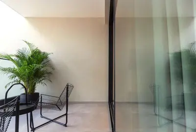 a room with a table and chairs and a plant at Aweso Limassol in Limassol