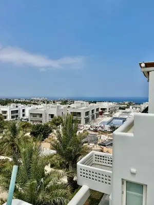 a view of a city with palm trees and buildings at Terra Vista in Kérynia