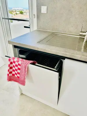 a kitchen with a counter with a red and white towel at Terra Vista in Kérynia