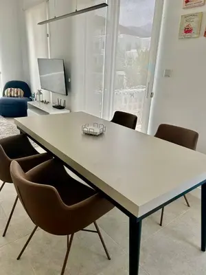 a large white table with chairs in a room at Terra Vista in Kérynia