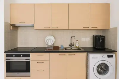 a kitchen with a sink and a dishwasher at Maison Amalthea in Limassol
