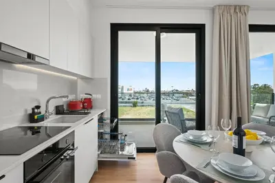 a kitchen with a table with chairs and a dining room at Artemis 202 - Seaside Stories in Livadhia