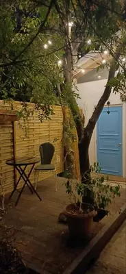 a chair sitting on a patio with a tree at Jay's Nest in Larnaka