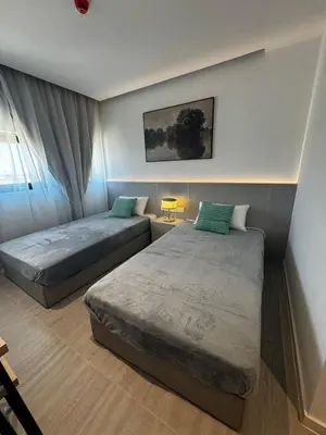 a bedroom with two beds and a window at AppleGym sports centre in Laxia