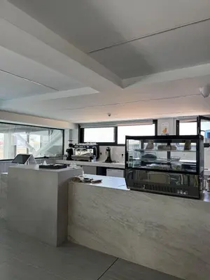 a large kitchen with a counter and a counter top at AppleGym sports centre in Laxia