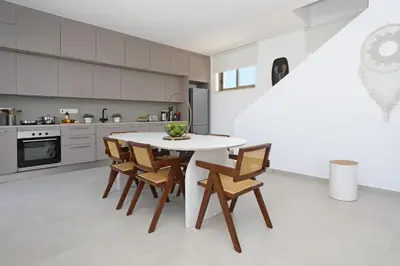 a kitchen with a white table and chairs at Princess Zena Luxury Villa - Large Pool in Protaras