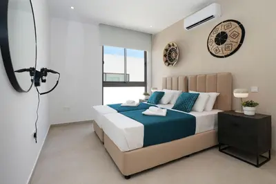 a bedroom with a bed and a clock on the wall at Princess Zena Luxury Villa - Large Pool in Protaras