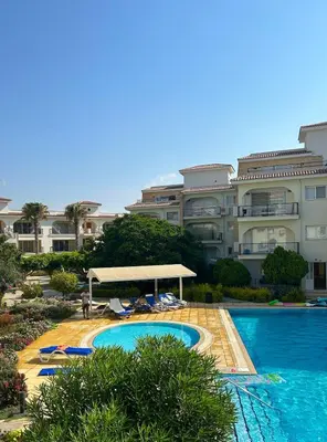 a large building with a swimming pool in front of it at Sunrise Beach Club, Bogaz, North Cyprus in Boğaz