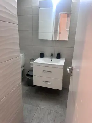 a bathroom with a white sink and a mirror at Faneromeni 33 in Scala