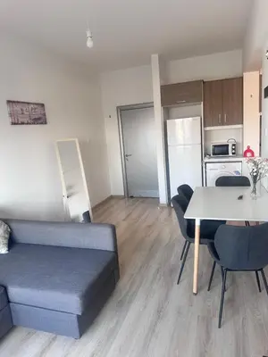 a living room with a couch and a table at Faneromeni 33 in Scala