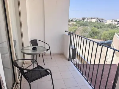 a balcony with a table and chairs and a view at Fresh & Cozy-close to the beach in Paralimni