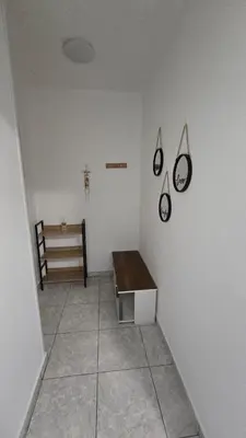 a room with a table and a bench on a wall at ERIKA Sea Breeze Makenzie in Larnaka