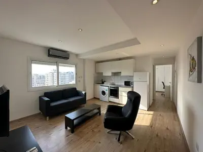 a living room with a couch and a chair at Premium City Center 10th Floor Sky View -Suite 103 in Nicosia