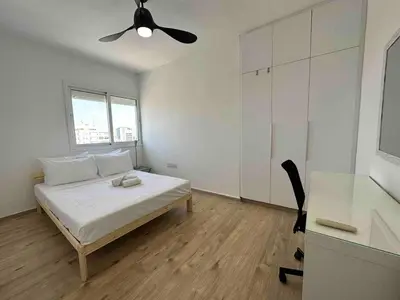 a white bedroom with a bed and a ceiling fan at Premium City Center 10th Floor Sky View -Suite 103 in Nicosia
