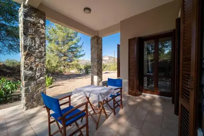 a table and chairs on a patio with a view at Casa Harmonia Traditional Stone House, Escape to Silence Soul and Serenity in Nature with 2 Bedrooms, Fireplace and Mountain Breeze in Mandria