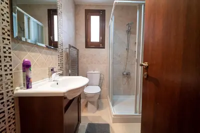 a bathroom with a toilet and a sink and a shower at Casa Harmonia Traditional Stone House, Escape to Silence Soul and Serenity in Nature with 2 Bedrooms, Fireplace and Mountain Breeze in Mandria