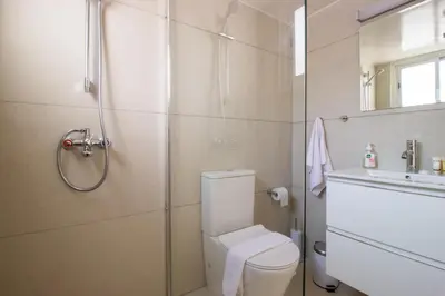 a bathroom with a shower and a toilet and a sink at Sea View Stay 200m to Beach in Voroklini