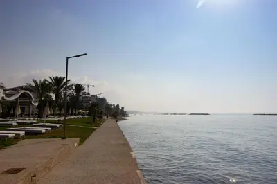a sidewalk next to a large body of water at Sea View Stay 200m to Beach in Voroklini