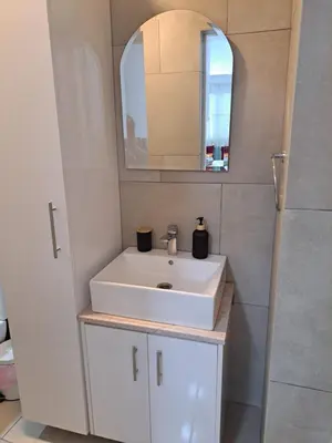 a bathroom with a white sink and a mirror at The Heart of Moutoullas in Moutoullas