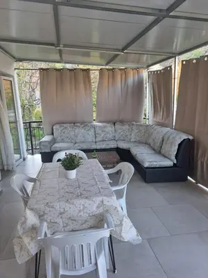 a living room with a couch and a table and chairs at The Heart of Moutoullas in Moutoullas