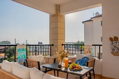 a balcony with a table and chairs with a view at TelMar Sunrise View 100m from the Sea in Larnaka