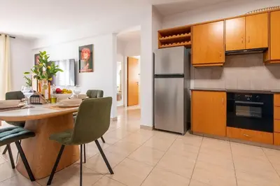 a kitchen with a table and a dining room at TelMar Sunrise View 100m from the Sea in Larnaka